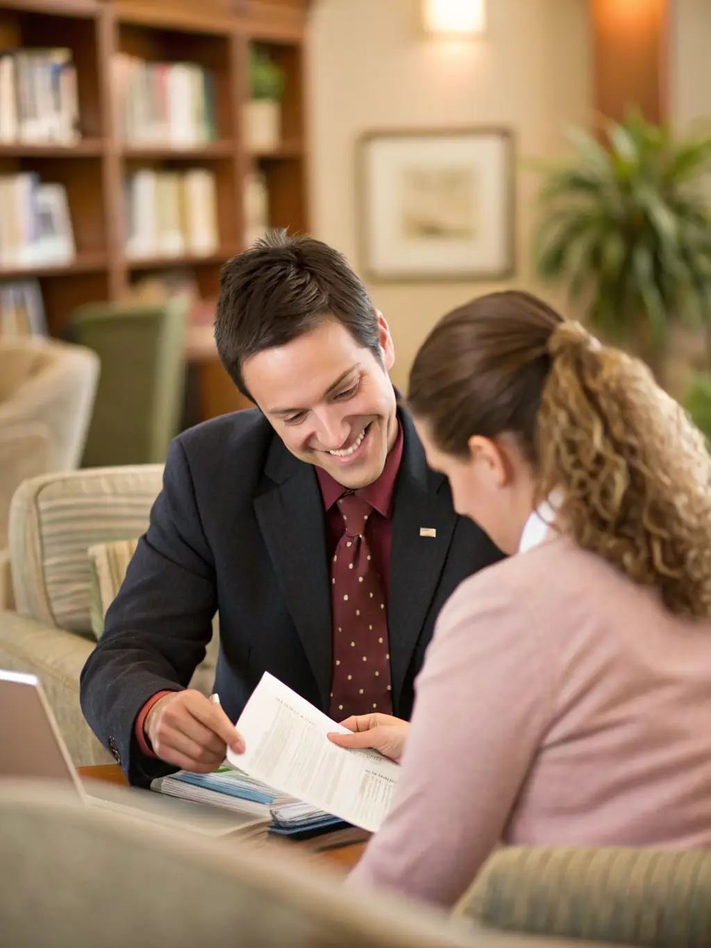 A professional, friendly banker assisting a customer with opening a new personal checking account at Grasshopper Bank, modern and bright branch interior.